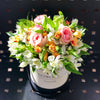 pini roses white alstroemerias in a hat box