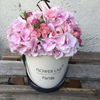 Pink hydrangea and mini roses in a hat box