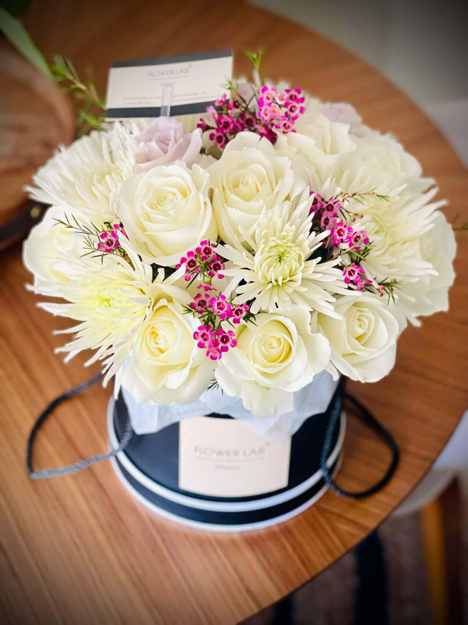 Sasha box with white roses, chrysanthemums and wax filler