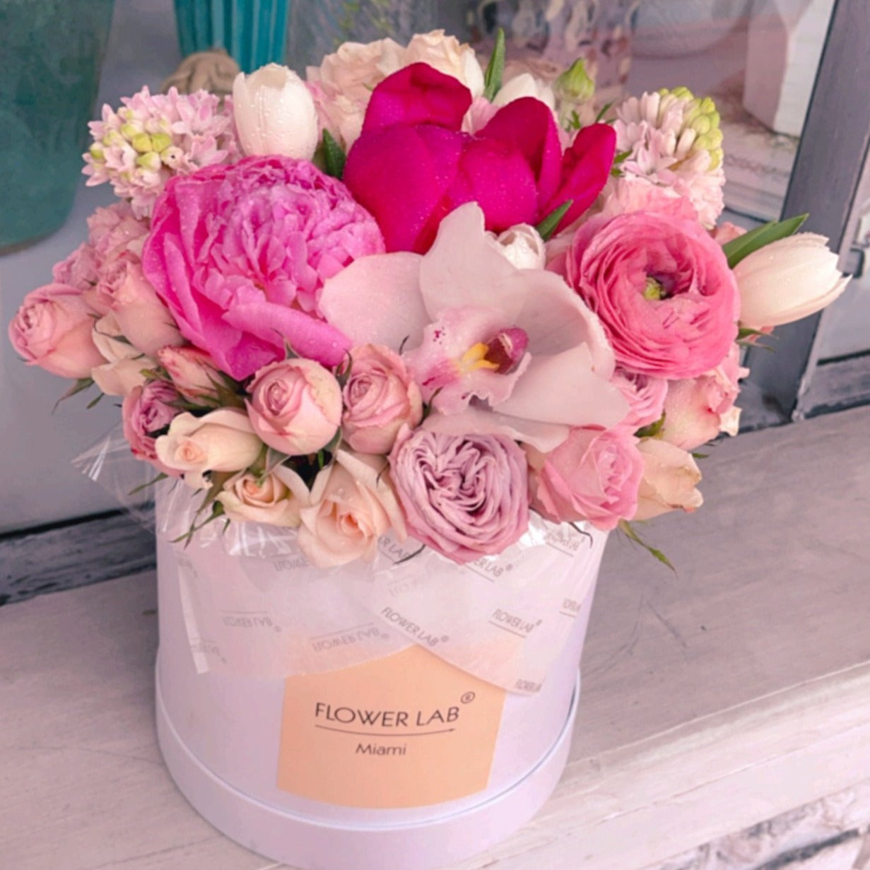Rosey box with pink tulips, peonies, hyacinths