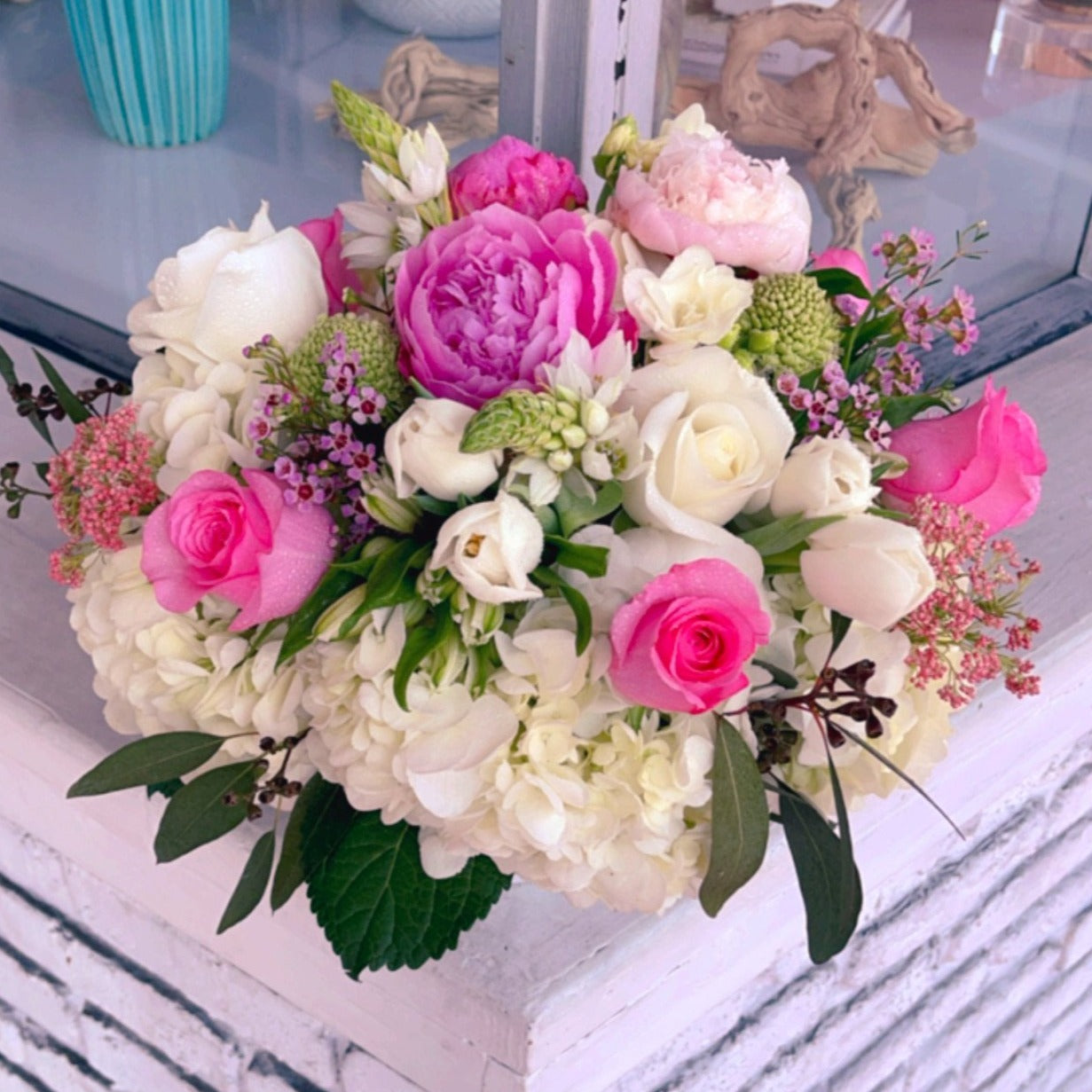 Florist choice bouquet in a vase with roses