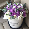 purple carnations, white flowers, eucalyptus, flowers in a box