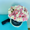 a mix of sprays and standard roses in a hat box