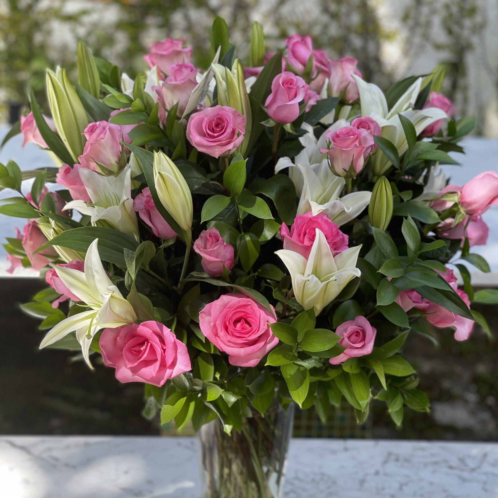 pink roses, lilies in a vase