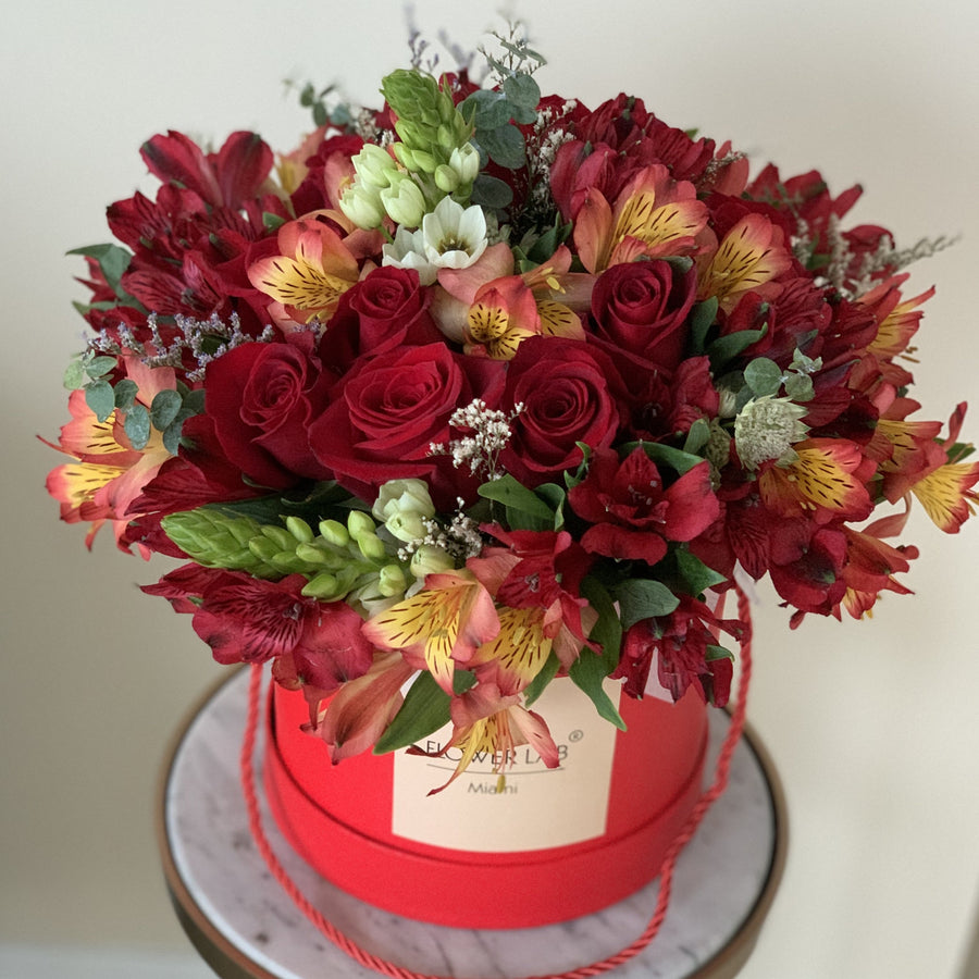 Roses and alstroemerias in a hatbox