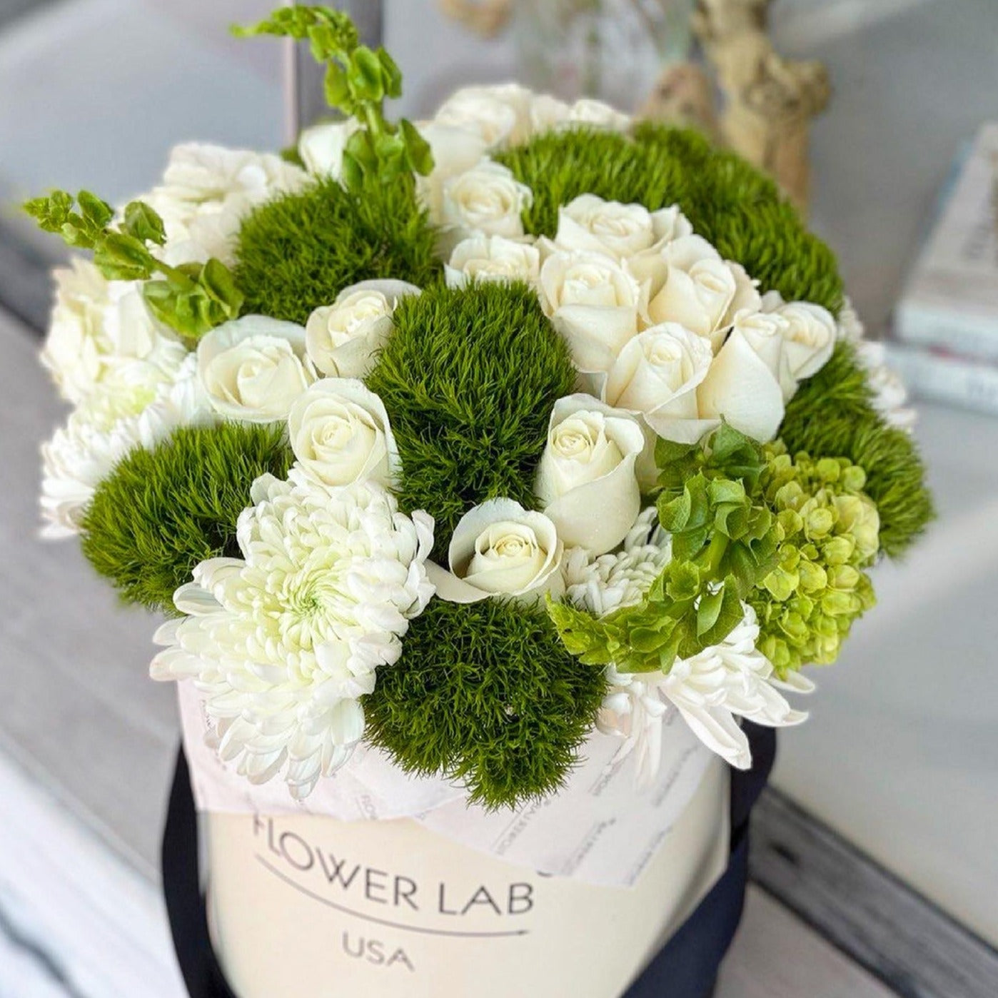 green ball and roses in a hatbox